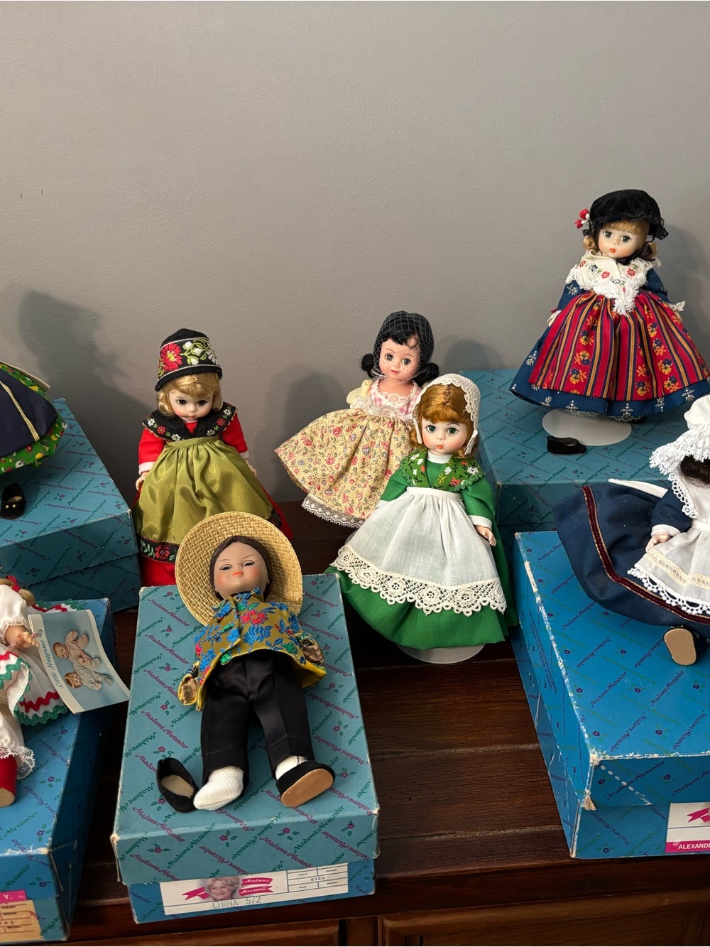 Madame Alexander Dolls Assortment Featuring Green, Red, Blue and White Outfits